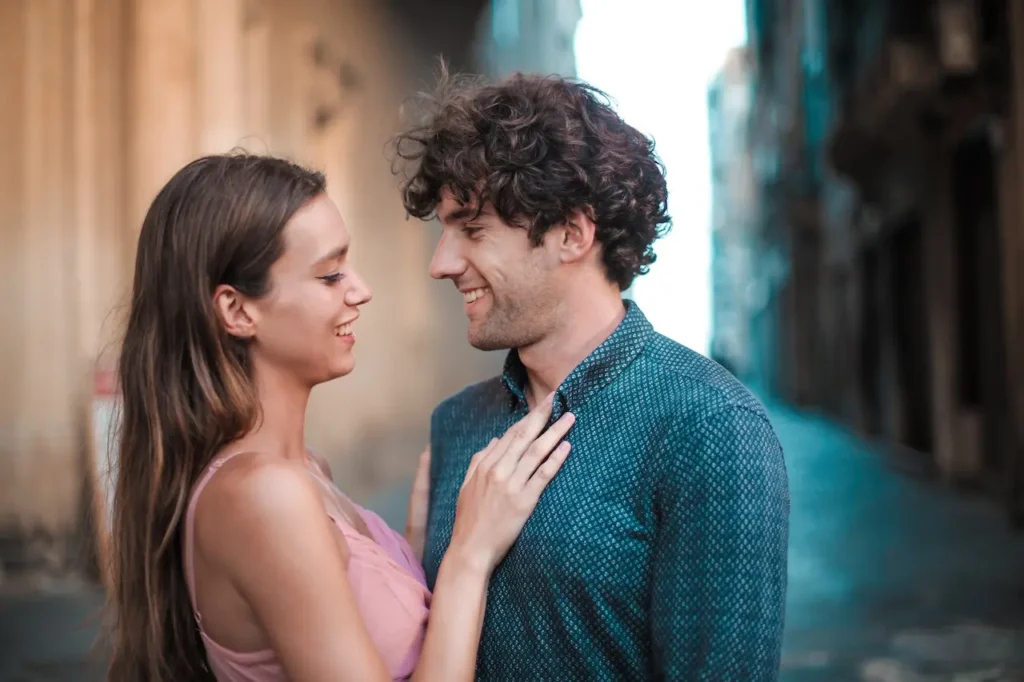 Happy couple smiling and flirting, representing playful attraction in dating